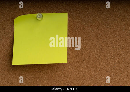 notebook blank paper sheet on corkboard in the office white wall Stock Photo