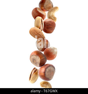 Falling nuts on white background Stock Photo