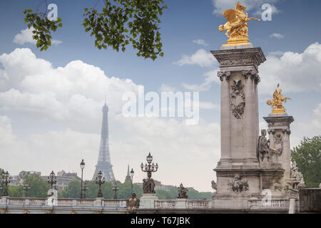 Golden monuments on the bridge Pont Alexander III bridge in Paris overlooking the background the eiffel tower Stock Photo