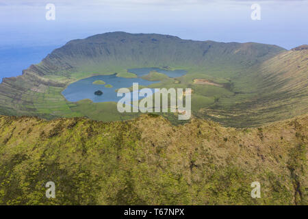 Aerial view of volcanic crater (Caldeirao) with a beautiful lake on the top of Corvo island. Azores islands, Portugal. Stock Photo