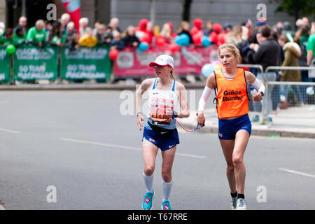 Charlotte Ellis (GBR), with her guide runner, competing in the World Para 2019 London Marathon. Charlotte went on to finish 7th, in a time of 03:23:47in the T11/12 Category Stock Photo