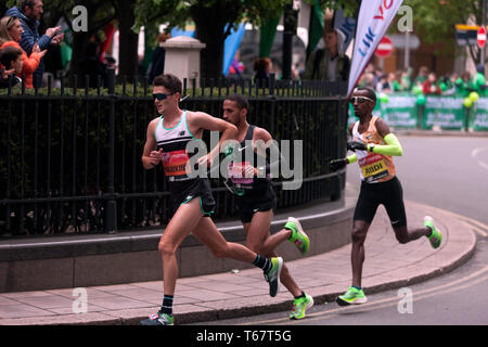 Callum Hawkins (GBR), Yassine Rachik (ITA) and Bashir Abdi (BEL), battling it out around Canary Wharf, during the 2019 London Marathon. They went on to finish 10th, 9th and 7th respectively  in the Men's elite race. Stock Photo