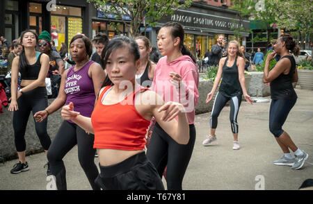 Women take part in an outdoor exercise class as part of the Car-Free Earth Day initiative in the Flatiron neighborhood of New York on Saturday, April 27, 2019 (Â© Richard B. Levine) Stock Photo