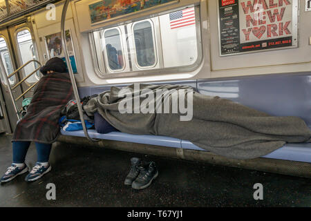 A homeless person sleeping on a subway train in Hudson Yards, New York ...