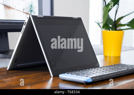 convertible laptop on office desk Stock Photo