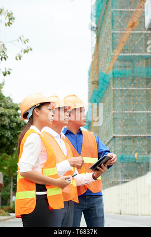 Group of architects working on construction site Stock Photo