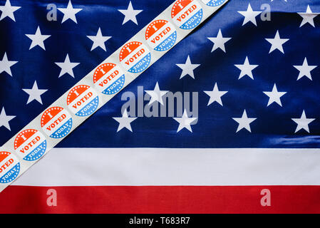 Sticker strip I vote today on the USA flag after voting in the ballot box. Stock Photo