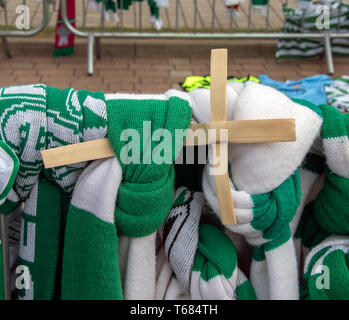 GLASGOW, SCOTLAND - 29th APRIL 2019:  A small wooden cross tucked into a Celtic scarf, Stock Photo