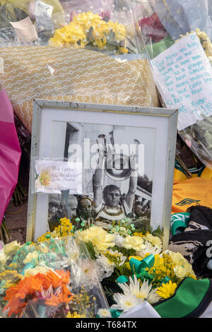 GLASGOW, SCOTLAND - 29th APRIL 2019:  A framed photo of Celtic icon, Billy McNeill, surrounded by flowers. Stock Photo