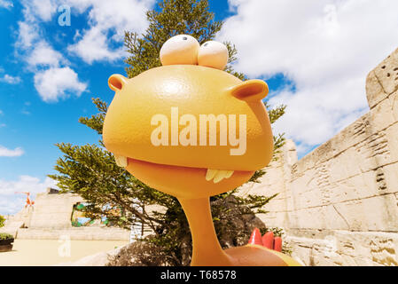 Funny doll in the shape of a dinosaur. Stock Photo