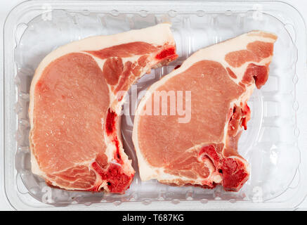 Two pork loin chops in a plastic butcher's tray Stock Photo