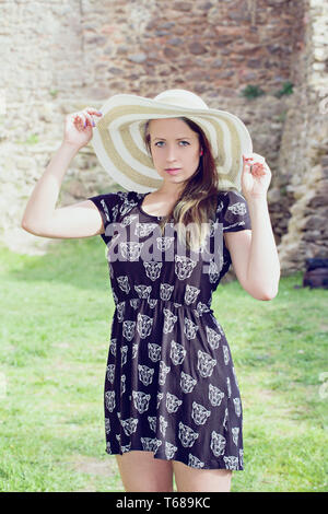 Young girl model poses to photographer. Female kid i beautiful dress  outside Stock Photo - Alamy