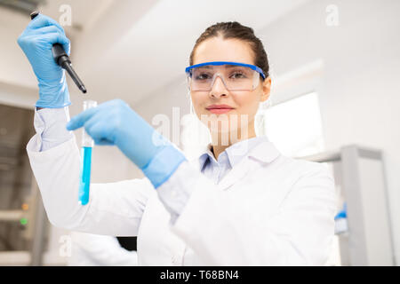 Woman conducting chemical test Stock Photo