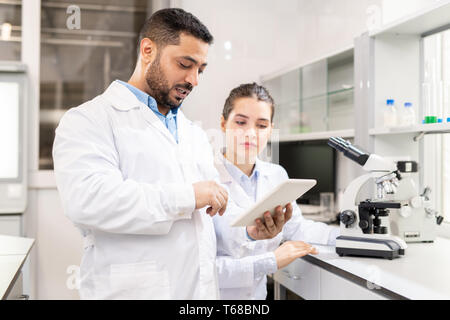 Examining test solution on tablet Stock Photo