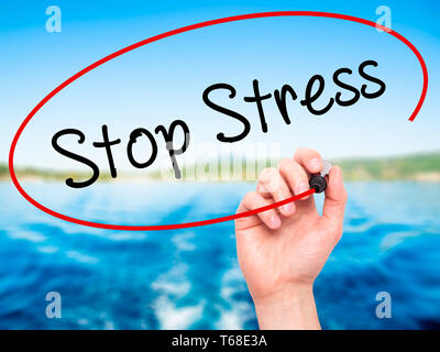 Man Hand writing Stop Stress with black marker on visual screen Stock Photo