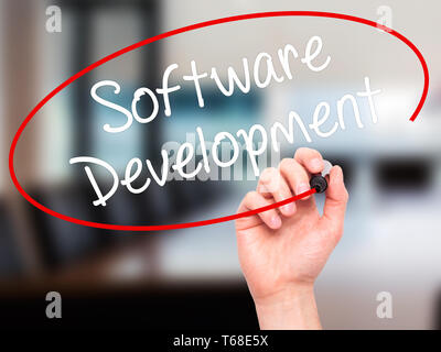 Man Hand writing Software Development with black marker on visual screen Stock Photo