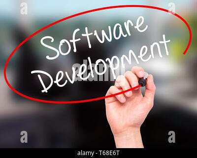 Man Hand writing Software Development with black marker on visual screen Stock Photo