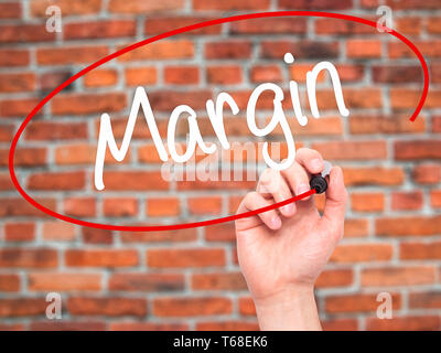 Man Hand writing Margin with black marker on visual screen Stock Photo