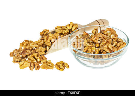 Handful of walnuts in scoop and glass bowl isolated. Stock Photo