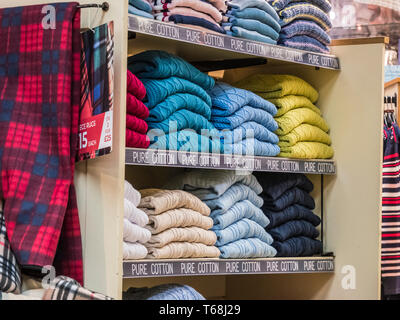 Colourful displays of mens ware on display at a town centre department store Stock Photo