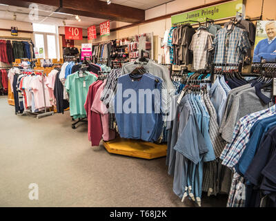 Colourful displays of mens ware on display at a town centre department store Stock Photo