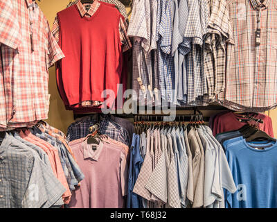 Colourful displays of mens ware on display at a town centre department store Stock Photo