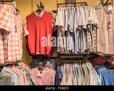 Colourful displays of mens ware on display at a town centre department store Stock Photo