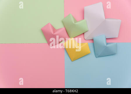 Heart shape made of torn pieces of colorful paper isolated over the white background Stock Photo