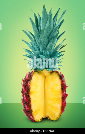 Cut painted pineapple on color background Stock Photo