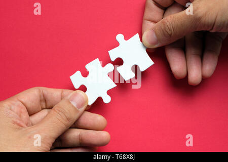 Partnership concept with hands putting puzzle pieces together