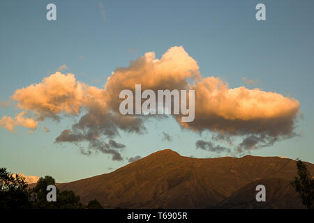 Multiple exposure of fluffy yellow clouds over Iguaque mountain, near the colonial town of Villa de Leyva, in the central Andes of Colombia. Stock Photo