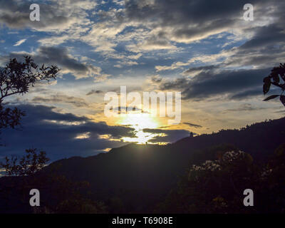 Minutes before the sun completely hides behind the Andean mountains of central Colombia. Stock Photo