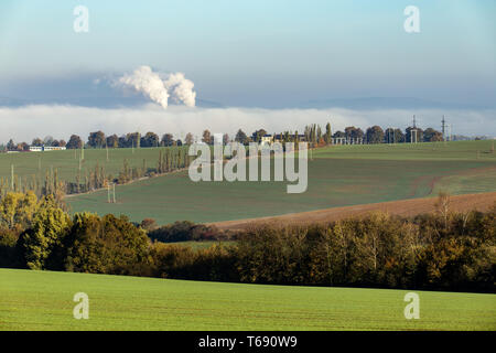 smoking chimneys in from factory hidden in mist Stock Photo