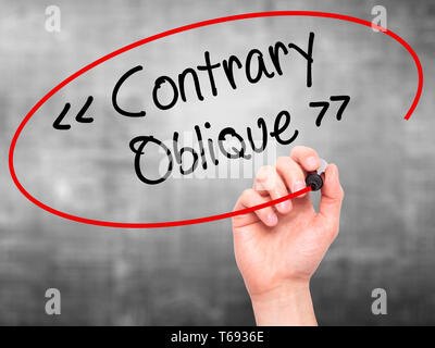Man Hand writing Contrary - Oblique with black marker on visual screen Stock Photo