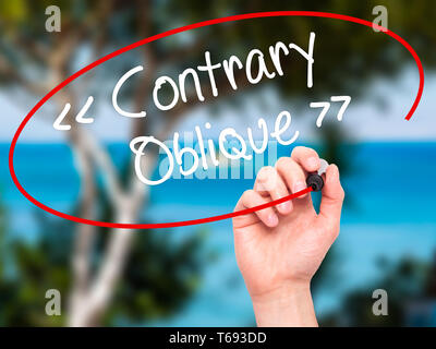 Man Hand writing Contrary - Oblique with black marker on visual screen Stock Photo