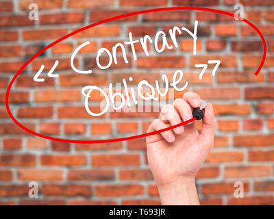 Man Hand writing Contrary - Oblique with black marker on visual screen Stock Photo