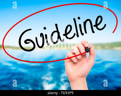 Man Hand writing Guideline with black marker on visual screen
