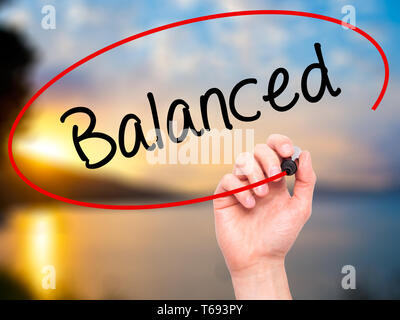 Man Hand writing Balanced with black marker on visual screen. Isolated ...