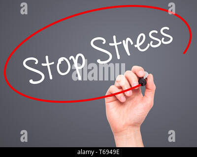 Man Hand writing Stop Stress with black marker on visual screen Stock Photo