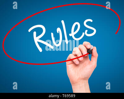 Man Hand writing Rules with black marker on visual screen. Stock Photo