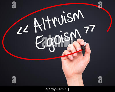 Man Hand writing Altruism - Egoism with black marker on visual screen. Stock Photo