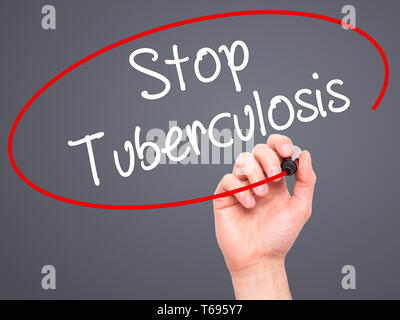 Man Hand writing Stop Tuberculosis with black marker on visual screen. Stock Photo