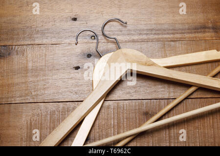 Close Up of Clothes Hangers on Wooden Background Stock Photo