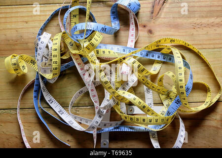 Tape Measures on Wooden Background Stock Photo