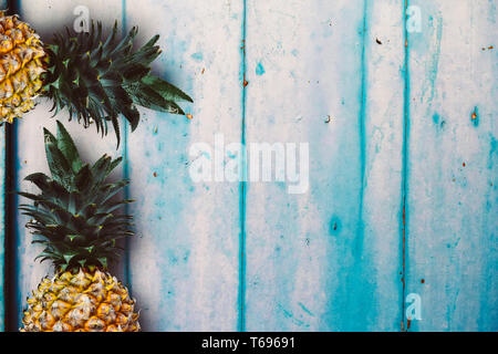 Ripe yellow pineapple over the rustic wooden table Stock Photo