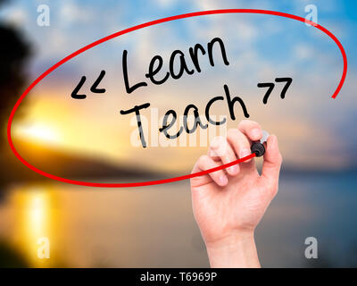 Man Hand writing Teach with black marker on visual screen Stock Photo ...