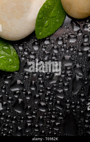 zen stones on black with water drops Stock Photo
