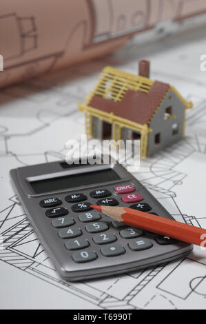 Model house on architectural plan with calculator Stock Photo