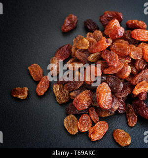 Organic Raisins. Black Background. Square crop. Closeup Stock Photo