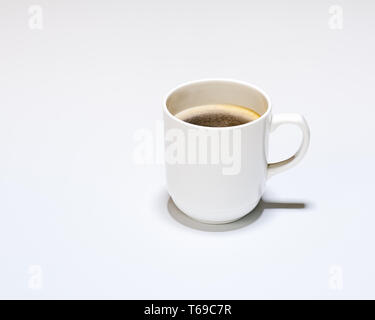White Cup of Hot Coffee on Gray Background. Stock Photo